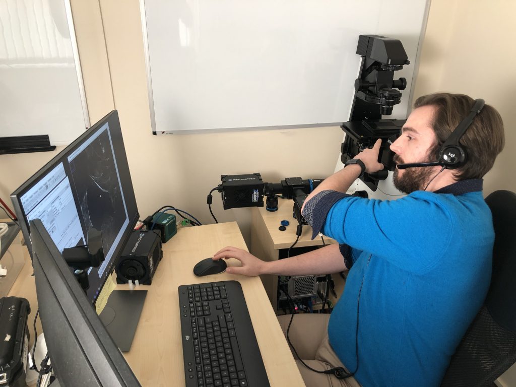 a researcher uses a video camera to record